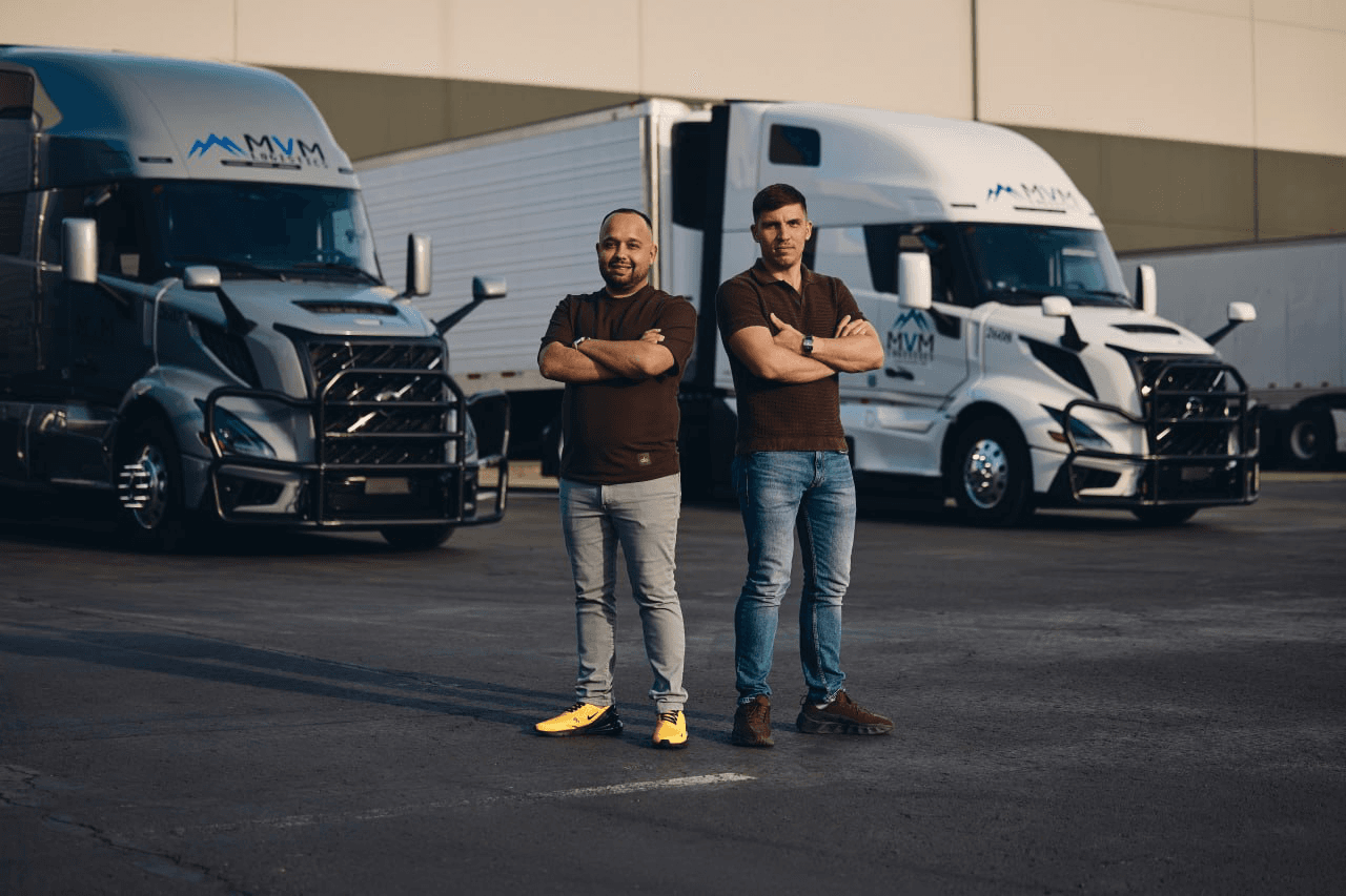 MVM Logistics co-founders Eugeniu Melinte and Dinu Mocan in front of the fleet